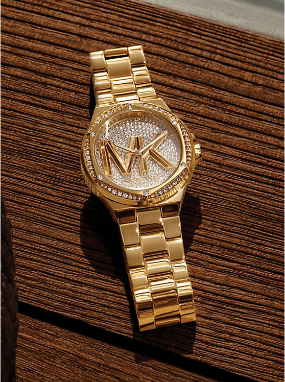 Mich@el Kors
Montre à logo Lennox dorée à pierres pavées et logo